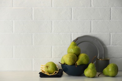 Fresh ripe pears on white table. Space for text