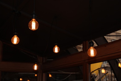 Glowing lamp bulbs in room. Interior element