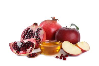 Honey, apples and pomegranates on white background. Jewish New Year (Rosh Hashanah) holiday