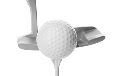 Hitting golf ball on tee with club against white background