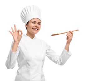 Photo of Happy female chef with wooden spoon showing ok gesture on white background