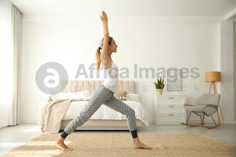 Young woman doing exercises at home. Morning fitness