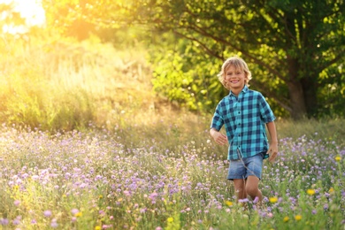 Cute little boy outdoors, space for text. Child spending time in nature