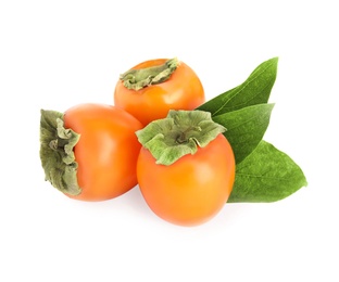 Delicious persimmons and green leaves isolated on white