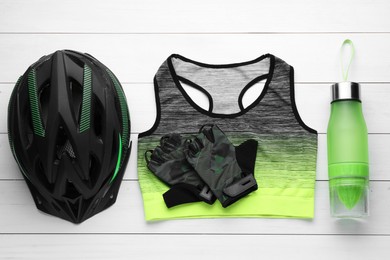 Flat lay composition with different cycling accessories on white wooden background