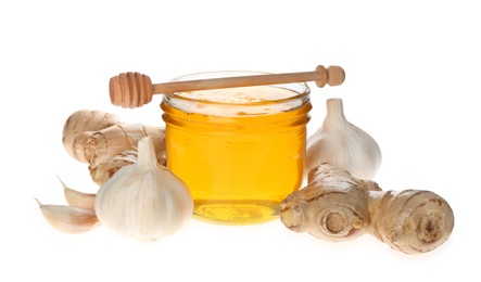Ginger, honey and fresh garlic on white background. Natural cold remedies