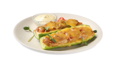 Baked stuffed zucchinis with sauce on white background