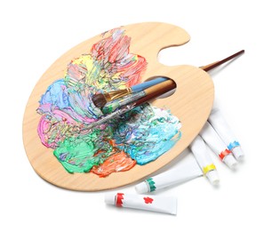 Palette with acrylic paints and brushes on white background. Artist equipment