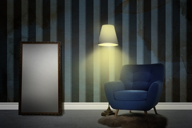 Armchair, floor lamp and mirror near wall patterned wallpaper. Stylish room interior