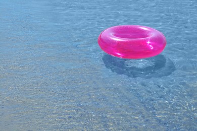 Bright inflatable ring floating in sea. Space for text
