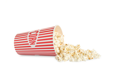 Overturned paper cup with delicious popcorn isolated on white