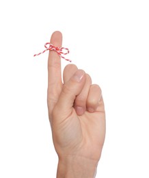 Photo of Woman showing index finger with tied bow as reminder on white background, closeup