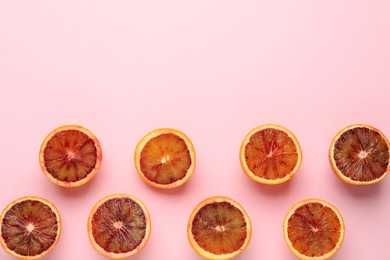 Many ripe sicilian oranges on pink background, flat lay. Space for text