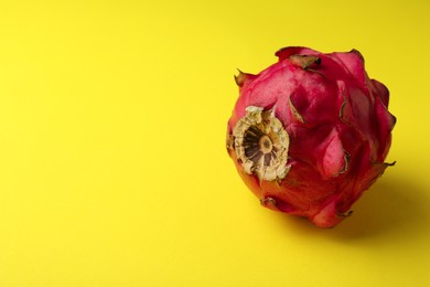 Delicious red pitahaya fruit on yellow background. Space for text