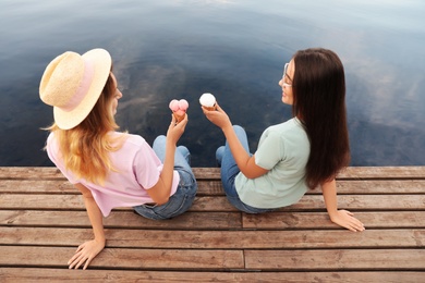 Young women with ice cream spending time together outdoors