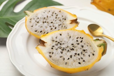 Plate with delicious cut dragon fruit (pitahaya) on table, closeup
