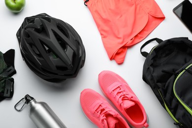 Photo of Flat lay composition with different cycling accessories and clothes on white background