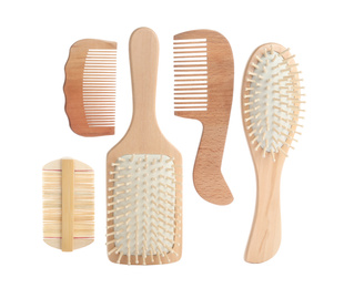 Different wooden hair brushes and combs on white background, top view