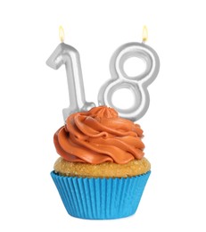 Delicious cupcake with number shaped candles on white background. Coming of age party - 18th birthday