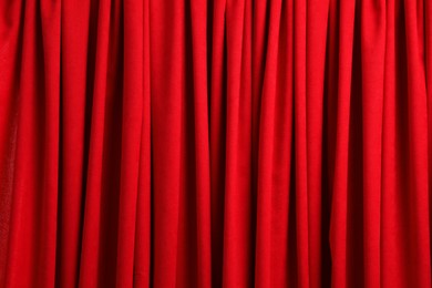 Closed elegant red front curtains as background, closeup