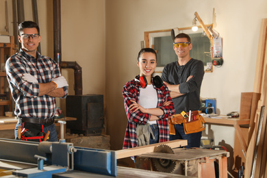 Team of professional carpenters in modern workshop