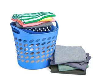 Photo of Plastic laundry basket and clean clothes isolated on white