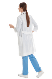 Doctor in clean uniform walking on white background