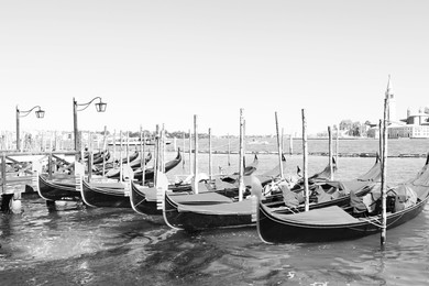 VENICE, ITALY - JUNE 13, 2019: Different gondolas at pier. Black and white tone 