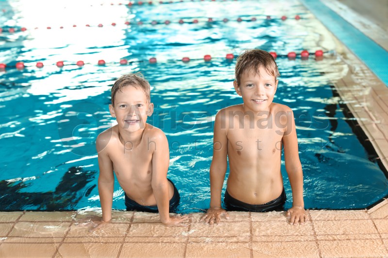 Cute little boys in indoor swimming pool