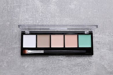 Photo of Contouring palette on light gray background, top view. Professional cosmetic product