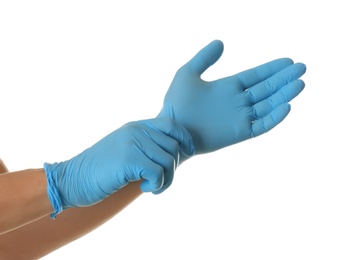 Person putting on blue latex gloves against white background, closeup