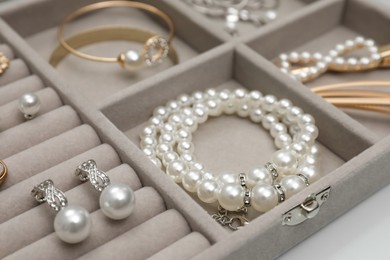 Box with luxurious pearl jewelry, closeup view