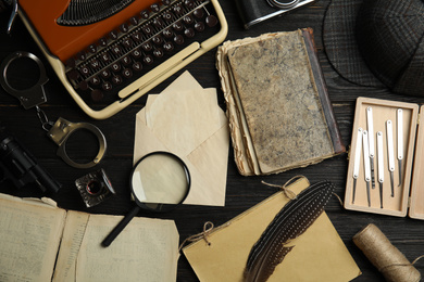 Composition with different vintage items on black wooden background. Detective's layout