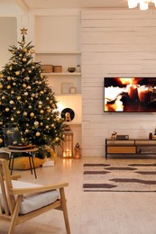 Plasma TV on white wooden wall in living room beautifully decorated for Christmas