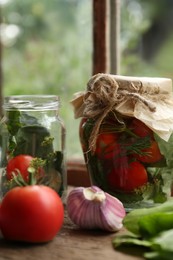 Glass jars and fresh vegetables on wooden table indoors. Pickling recipe