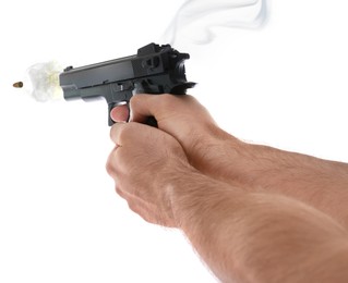 Man shooting from gun on white background, closeup