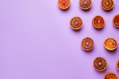 Many ripe sicilian oranges on violet background, flat lay. Space for text