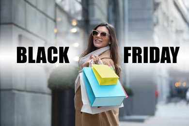 Image of Beautiful young woman with shopping bags on city street. Black Friday Sale