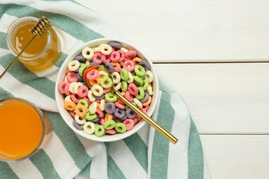 Bowl of sweet crispy corn rings, juice and honey on white wooden table, flat lay with space for text. Breakfast cereal