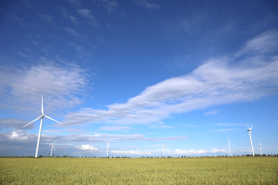 Beautiful view of field with wind turbines. Alternative energy source