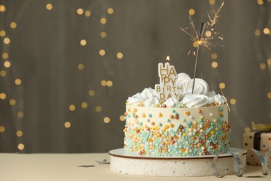 Beautiful birthday cake with festive decor on white table. Space for text