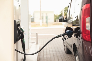 Photo of Refueling modern car at gas filling station, closeup