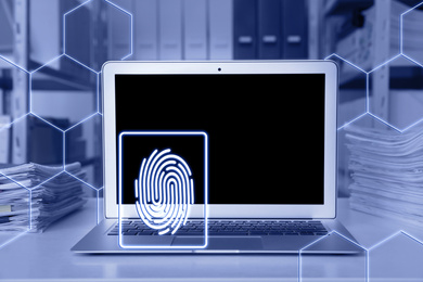 Fingerprint identification. Modern laptop on table indoors