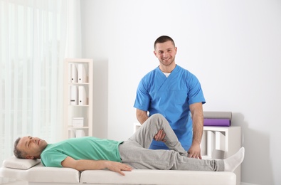 Doctor working with patient in hospital. Rehabilitation physiotherapy