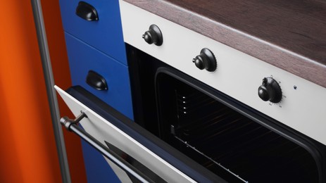 Photo of New stylish closed oven in kitchen. Cooking appliance