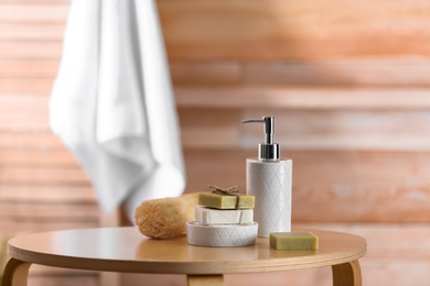Composition with soap and toiletries on table against blurred background. Space for text