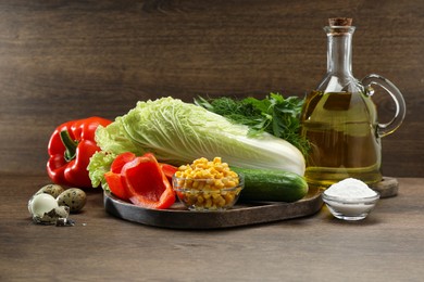 Chinese cabbage and different products on wooden table