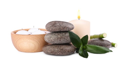 Photo of Spa stones, candles and bamboo on white background