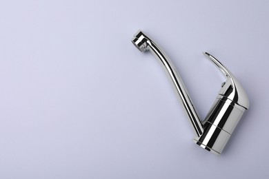 Photo of Single handle water tap on grey background, top view. Space for text