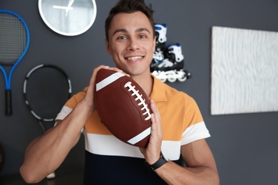 Portrait of sport blogger with football ball at home